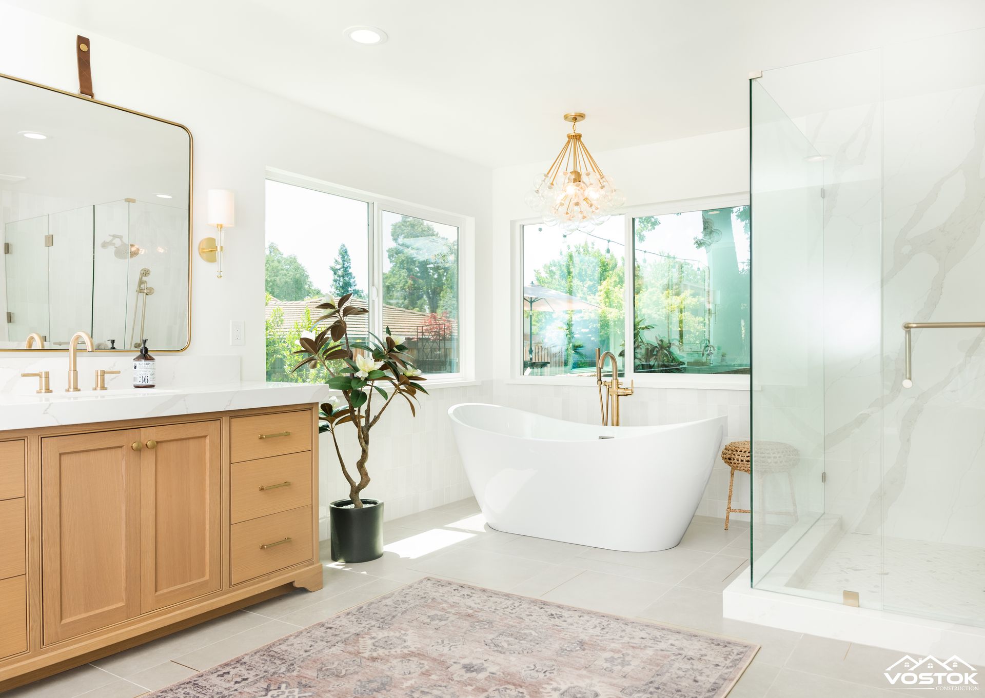 A bathroom with a tub , sink , mirror and walk in shower.