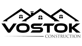 A black and white logo for a construction company called vostok construction.