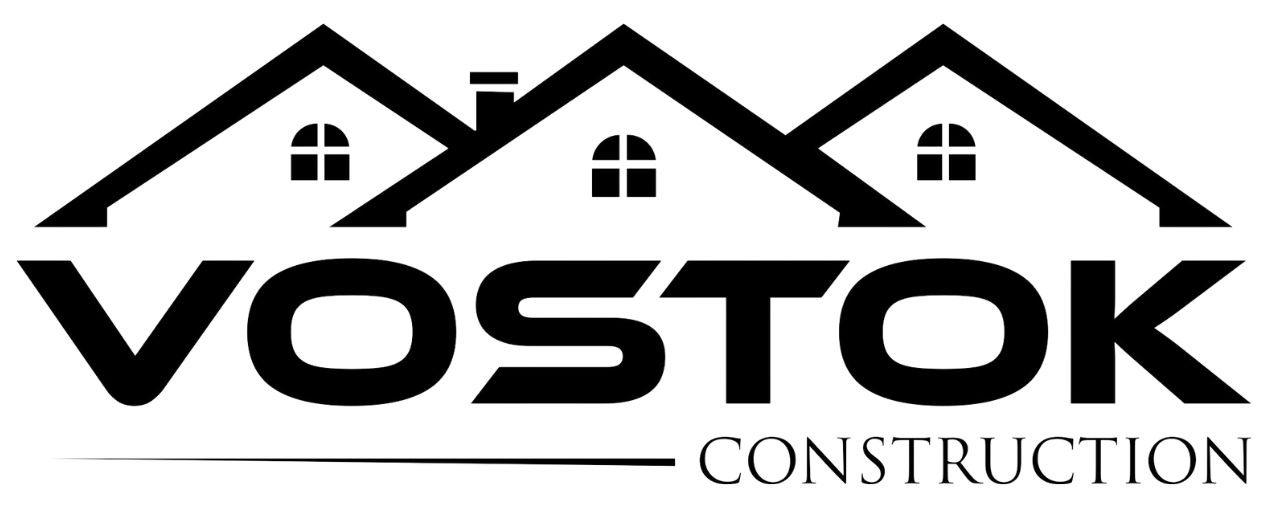 A black and white logo for a construction company called vostok construction.