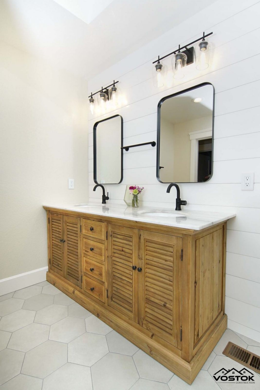 A bathroom with two sinks and two mirrors.