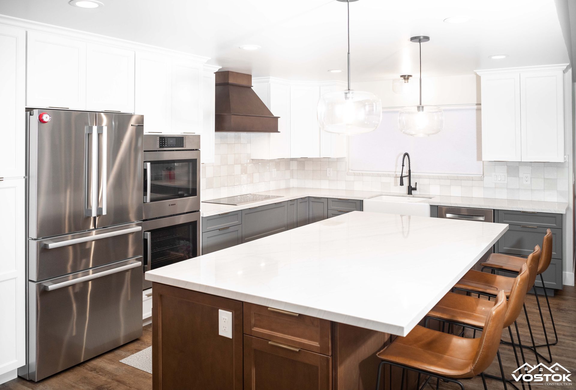 A kitchen with stainless steel appliances and a large island.