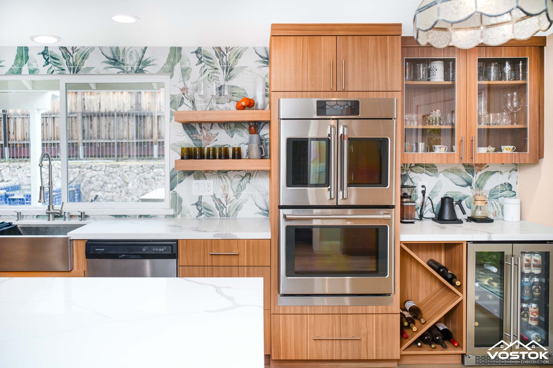 A kitchen with stainless steel appliances and wooden cabinets.