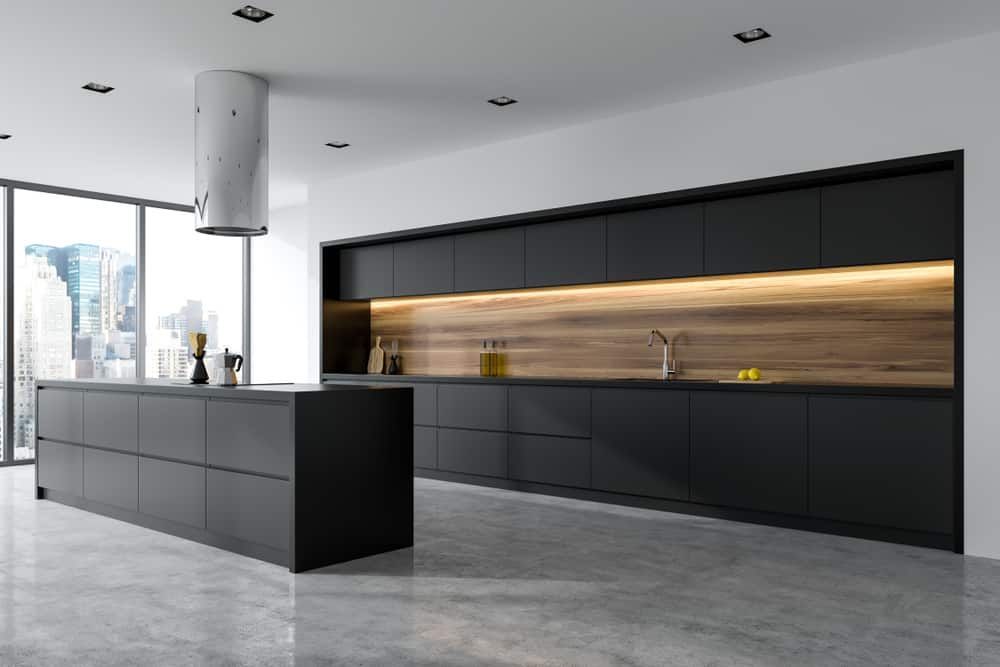 A Modern Kitchen With Black Cabinets And A Large Island In The Middle — South East Kitchens In Burleigh Heads, QLD