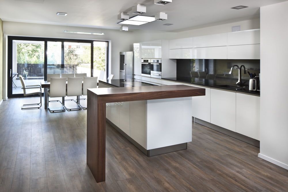 A Kitchen With White Cabinets And A Large Island In The Middle — South East Kitchens In Burleigh Heads, QLD