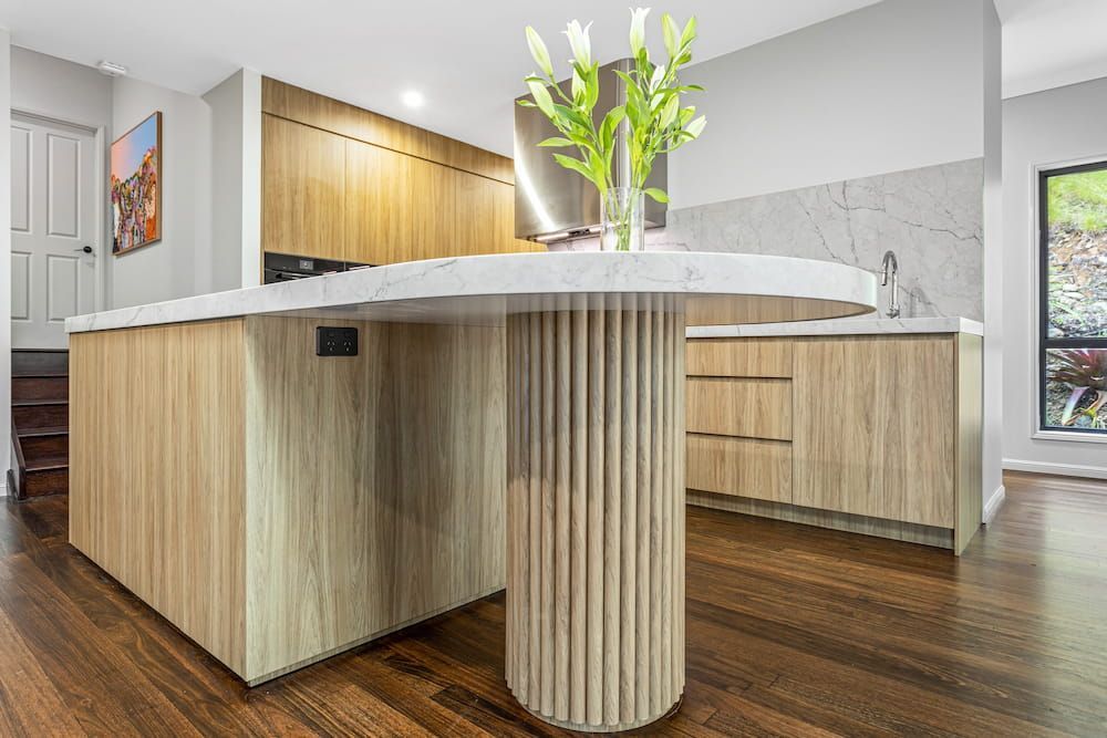 A Kitchen With A Wooden Island And A Marble Counter Top — South East Kitchens In Burleigh Heads, QLD