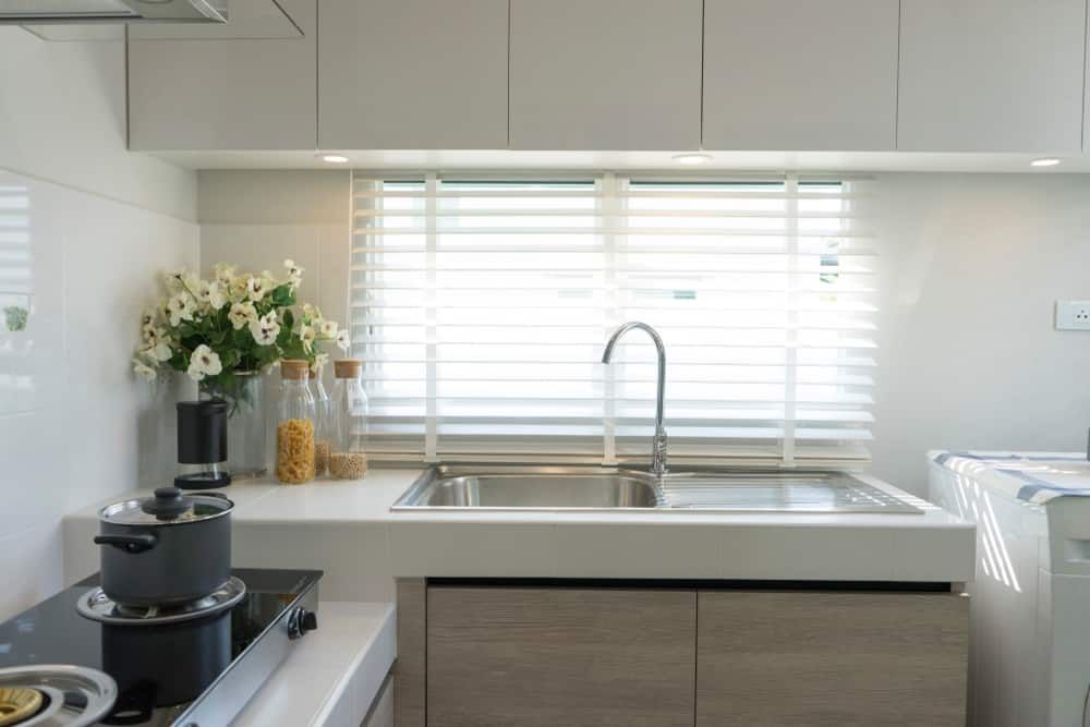 A Kitchen With A Sink, Stove, Pots And Pans, And A Window — South East Kitchens In Burleigh Heads, QLD