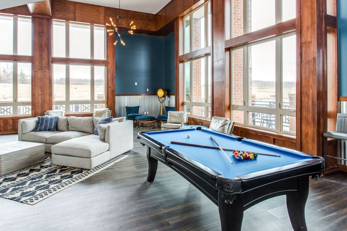 Enclave at Brockport game room with pool table