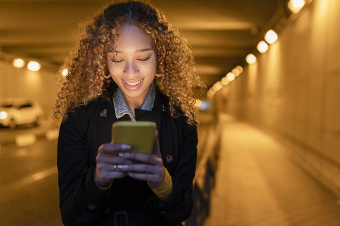 beautiful woman using her phone in a tunnel