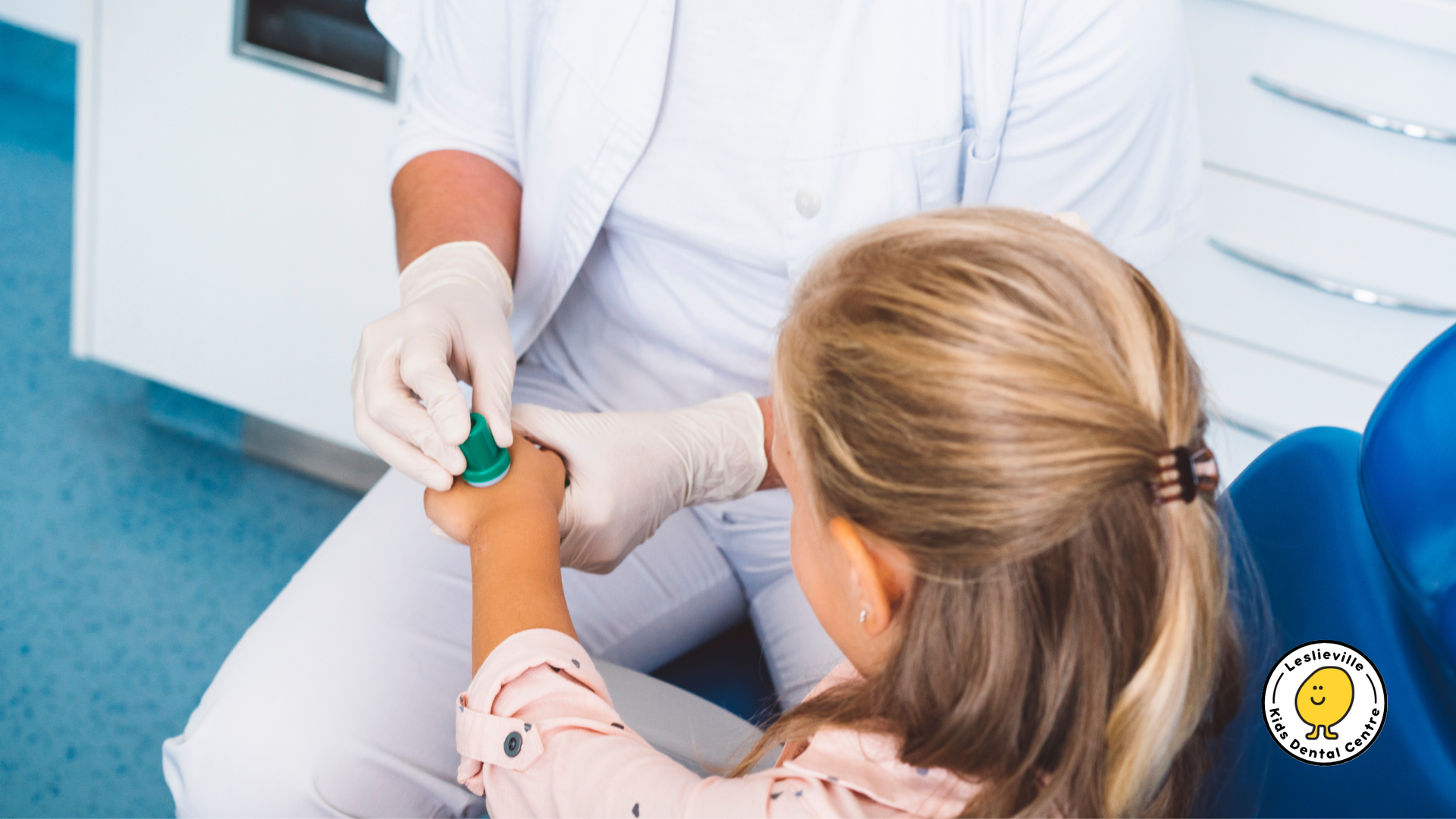 A little girl is getting an injection in her arm by a doctor.