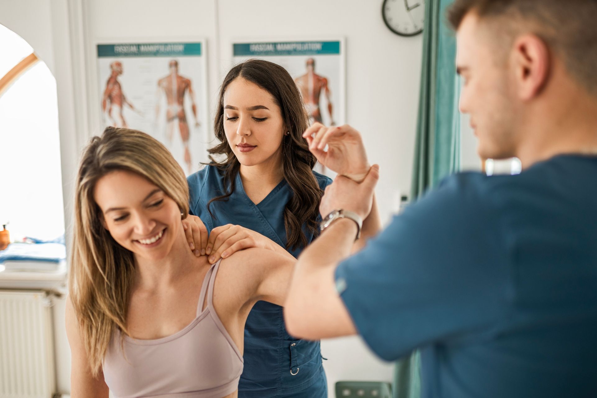 A woman is getting a massage from a doctor in a hospital.