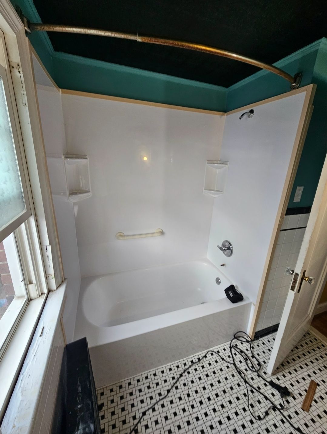 A bathroom with a bathtub and a shower stall.