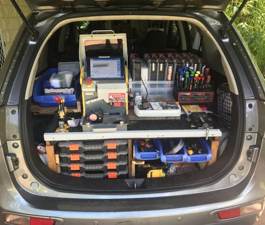 The Trunk Of A Car Is Filled With Tools And Boxes — Cassowary Coast Locksmiths In East Feluga, QLD