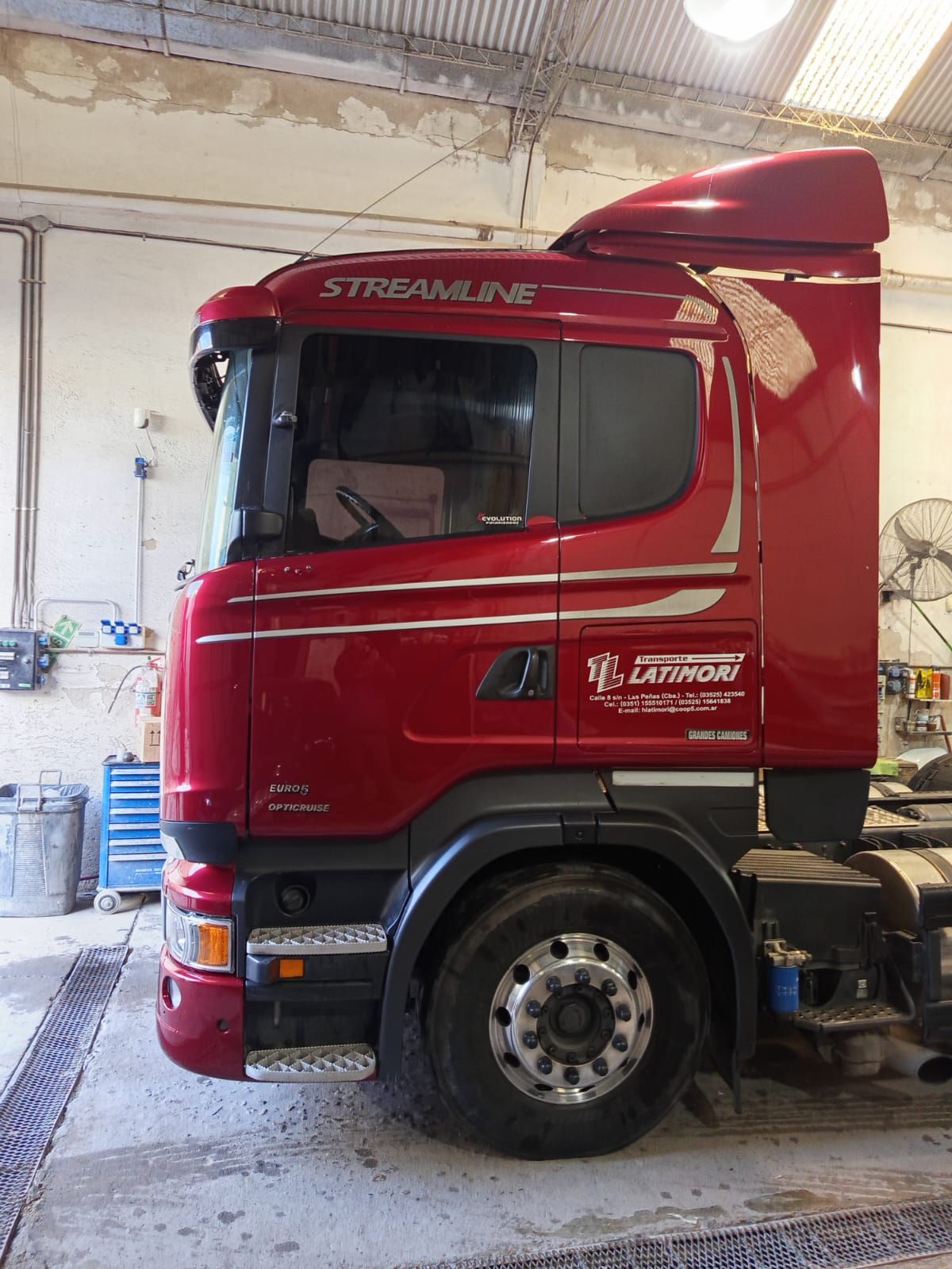 Cabina de camión Scania Streamline de color rojo en un garaje, vista lateral.