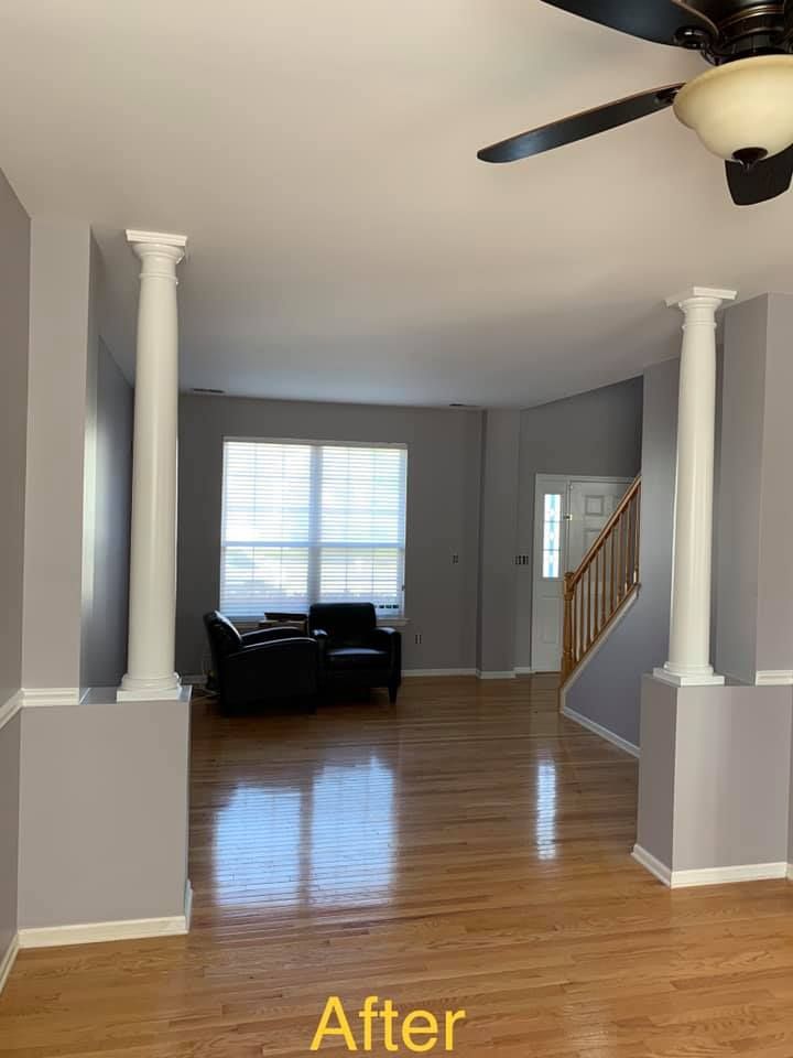 A living room with hardwood floors and a ceiling fan.