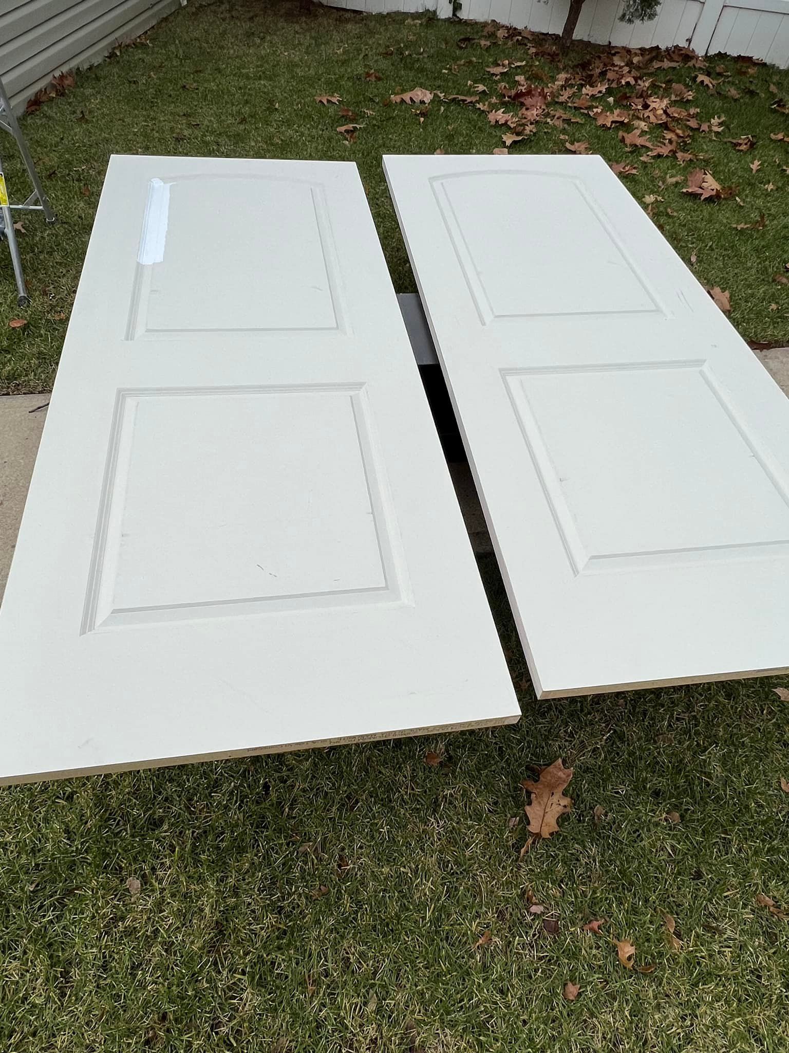 Two white doors are sitting on top of a lush green lawn — Pequannock Township, NJ — Alb Premium Painting