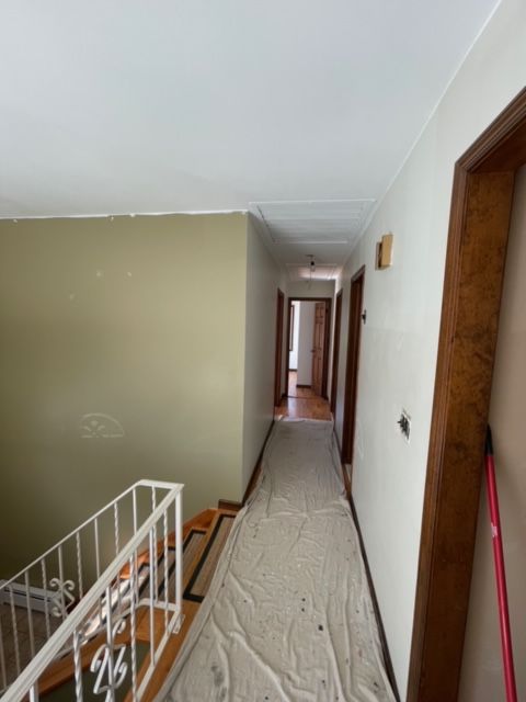 A hallway with a white tarp on the floor