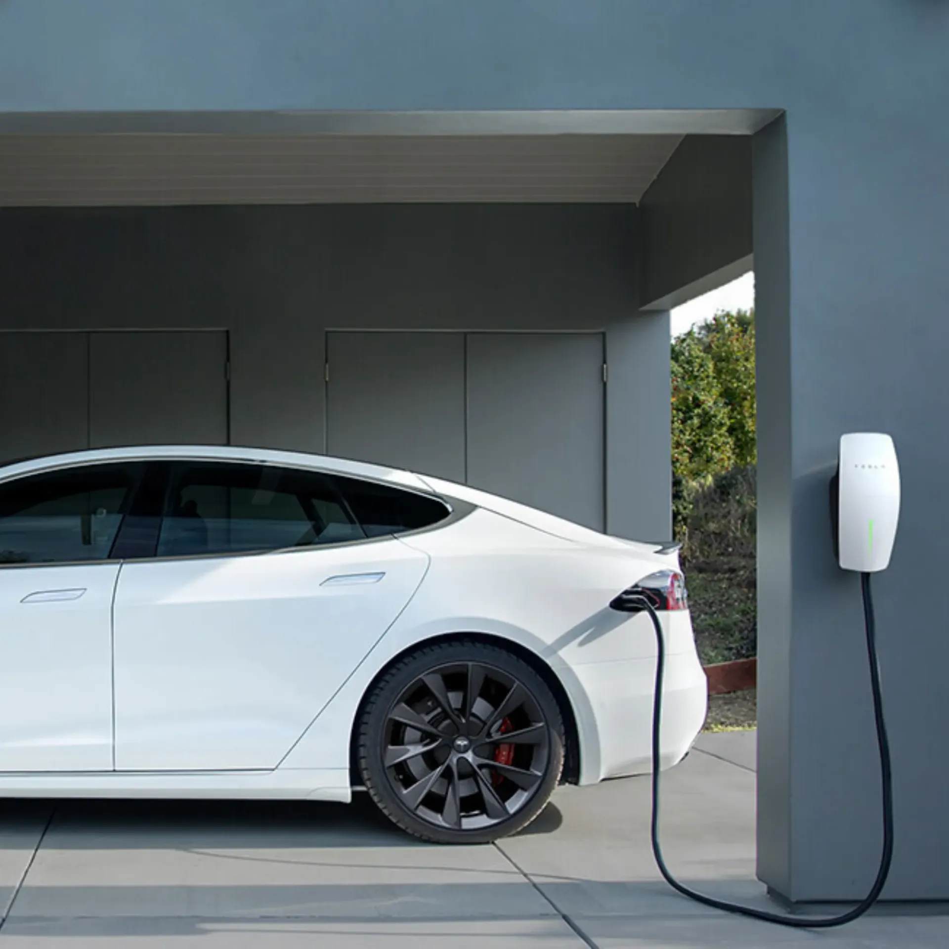 Horizon Electric USA - A white car is plugged into a charging station in a garage.