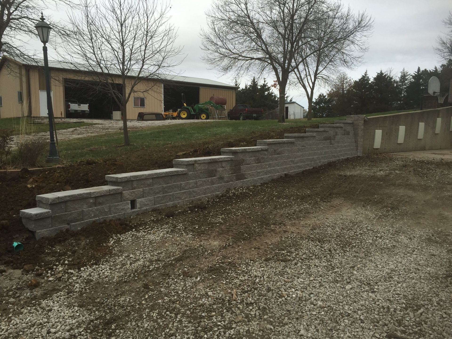 A brick wall is being built in front of a house.
