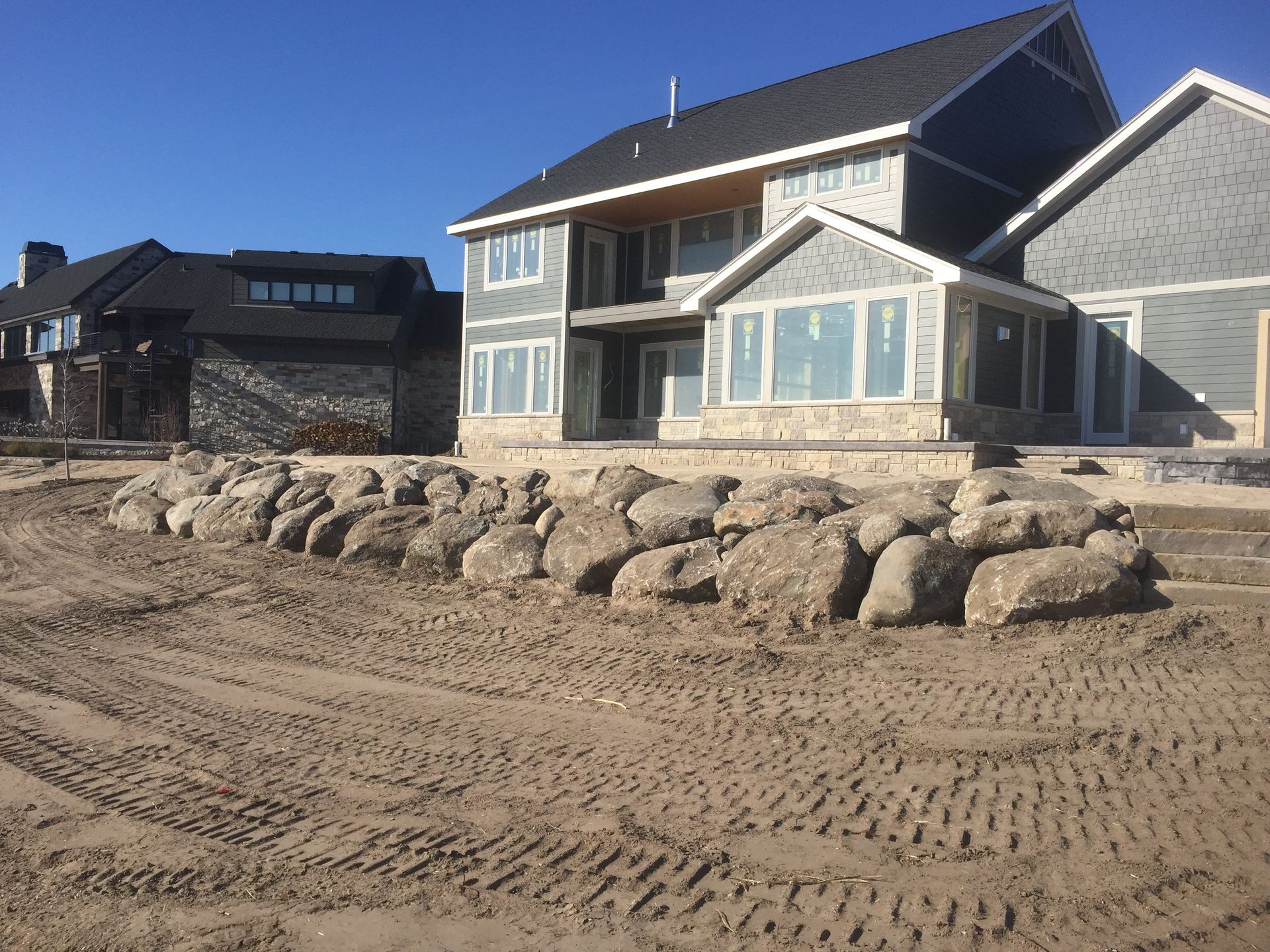 A large house with a lot of rocks in front of it.