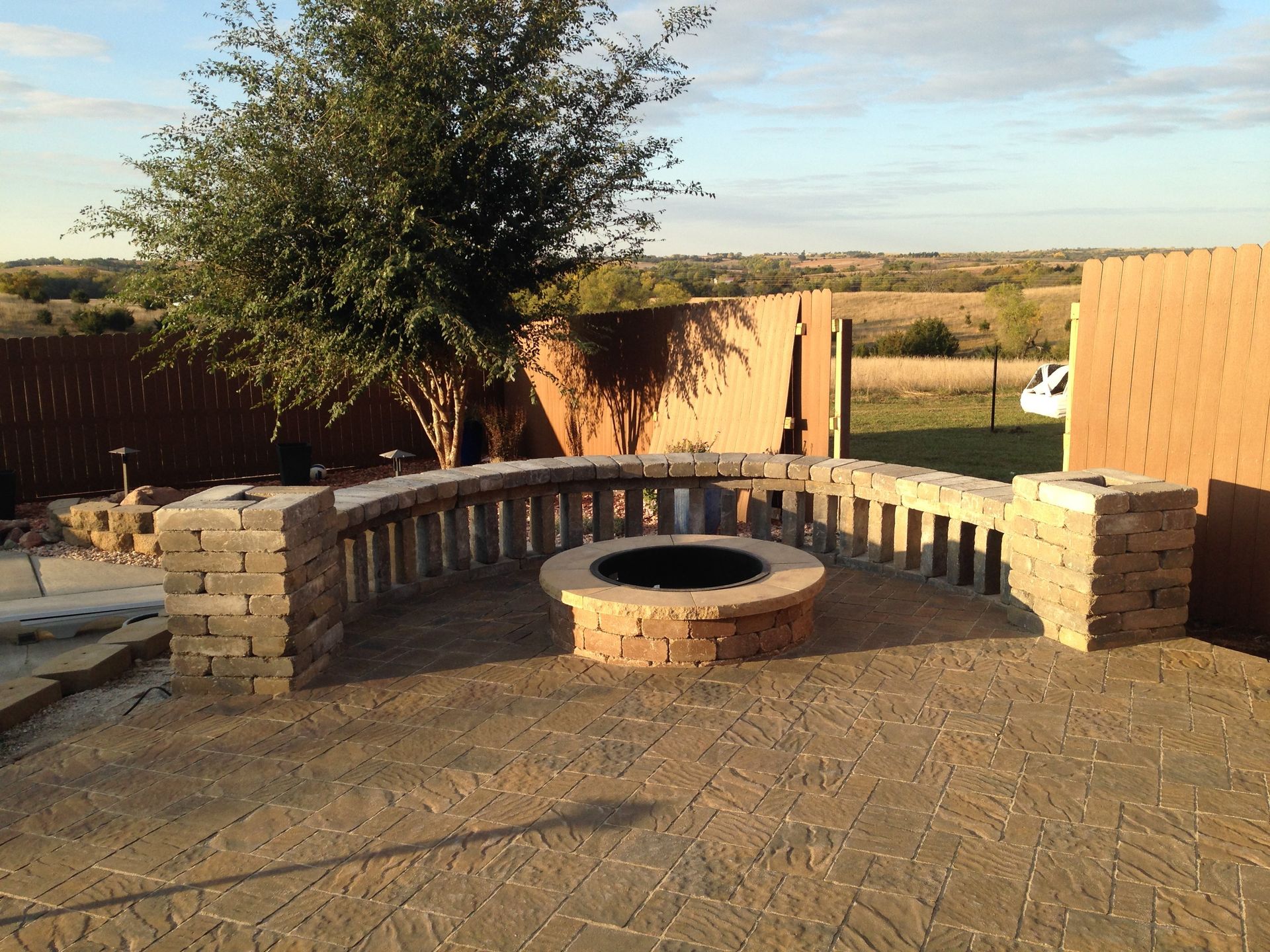 A fire pit sits in the middle of a patio