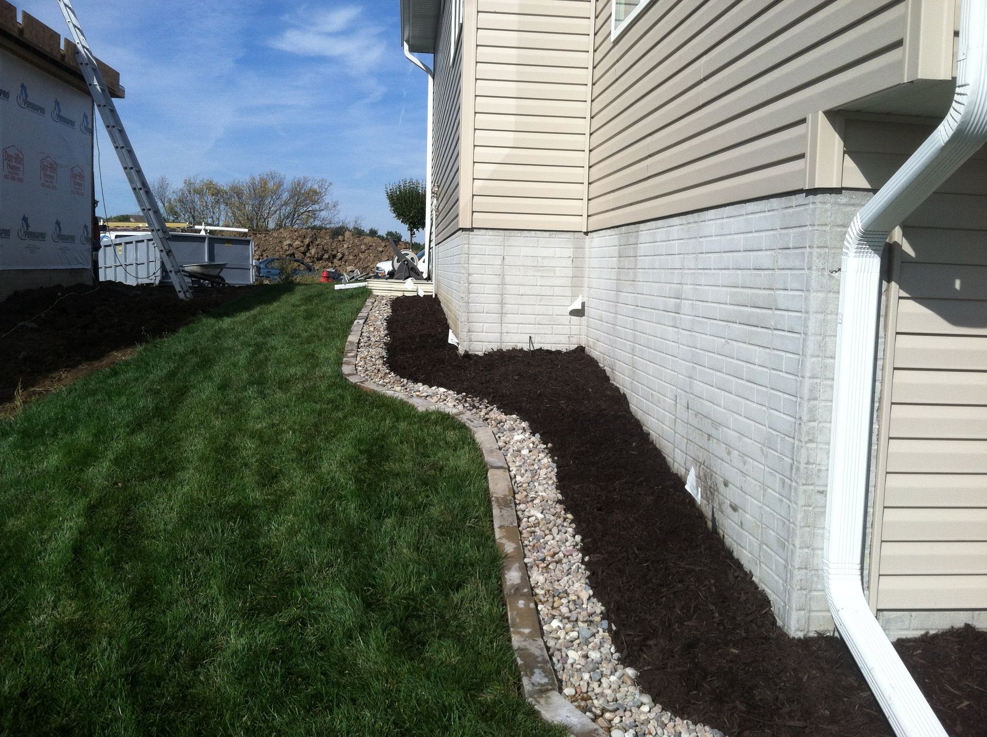 A house with a drain on the side of it
