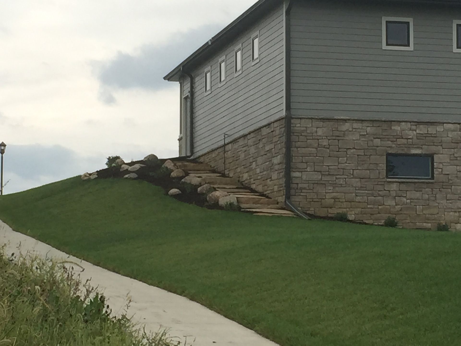 A house sits on top of a grassy hill