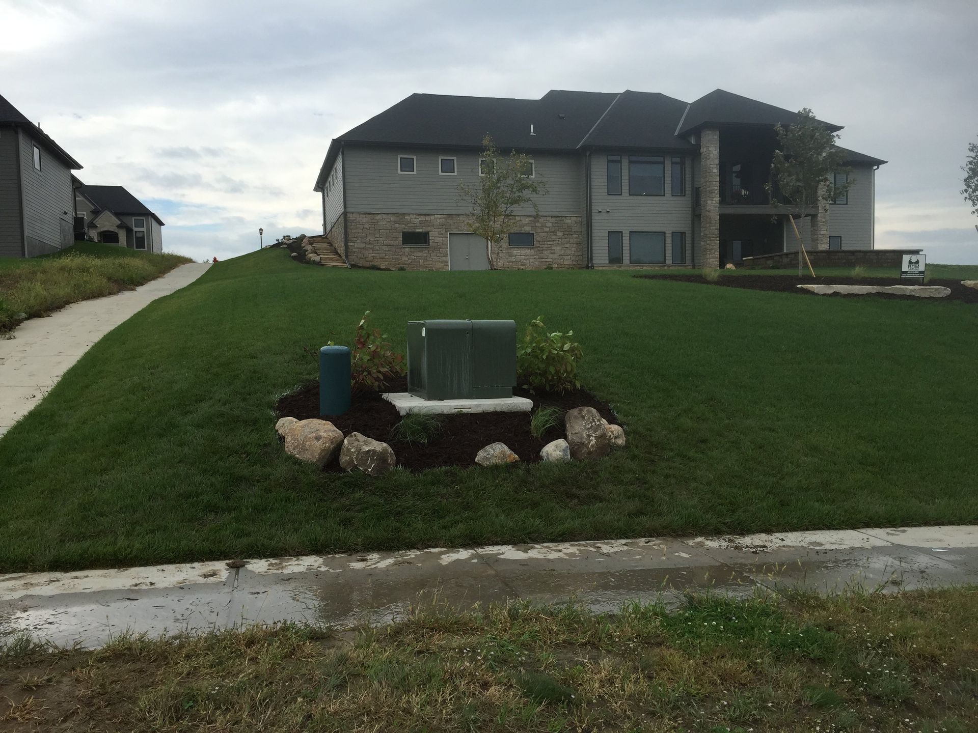 A large house with a lush green lawn in front of it