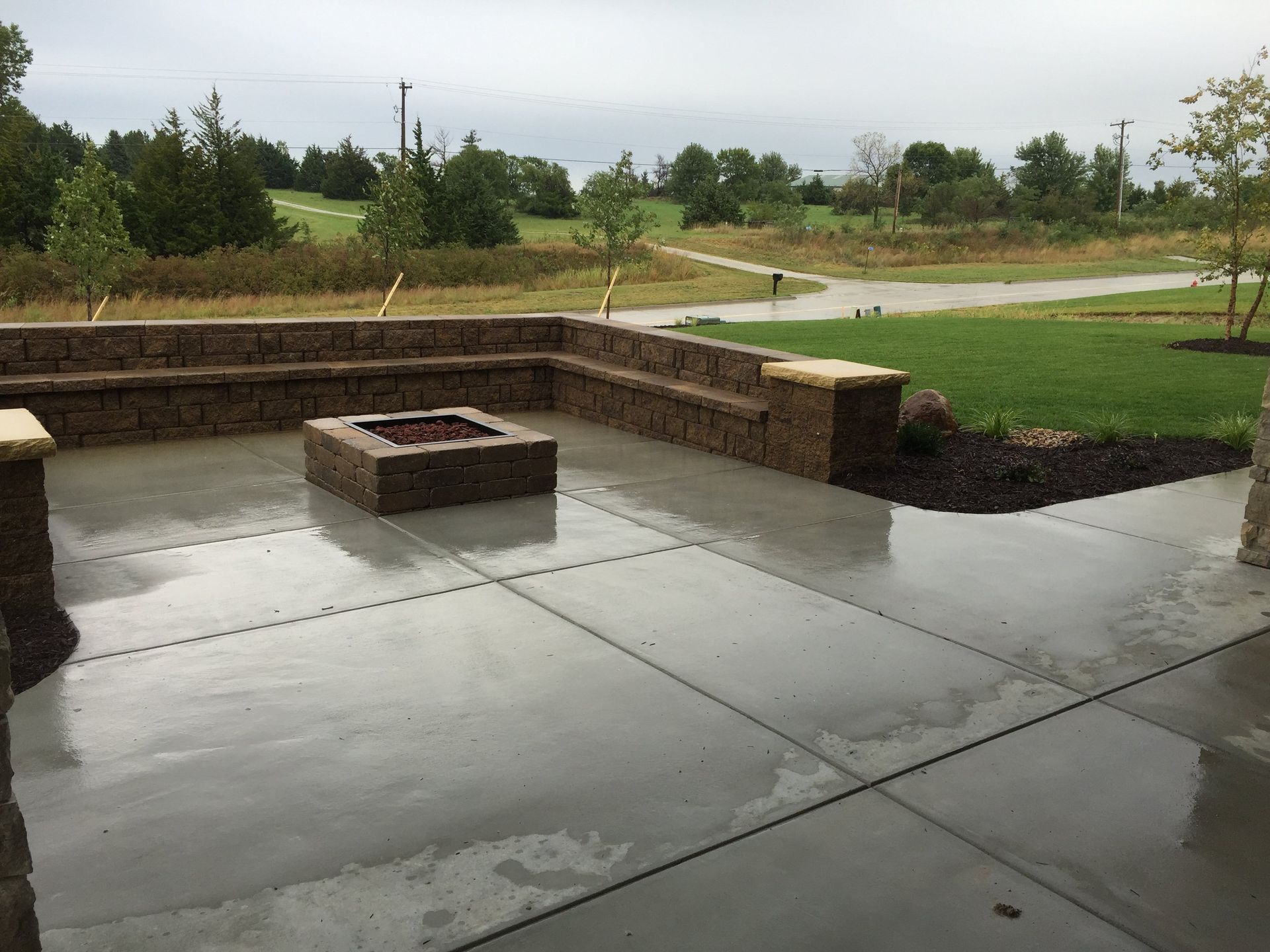 A patio with a fire pit in the middle of it