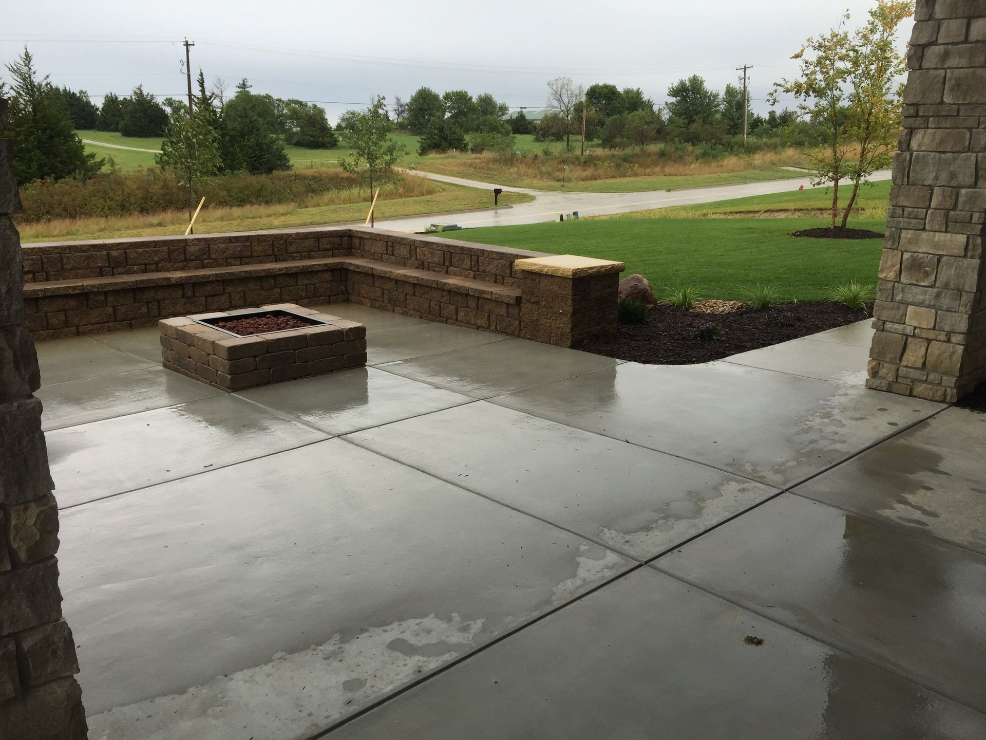 There is a fire pit in the middle of the patio.