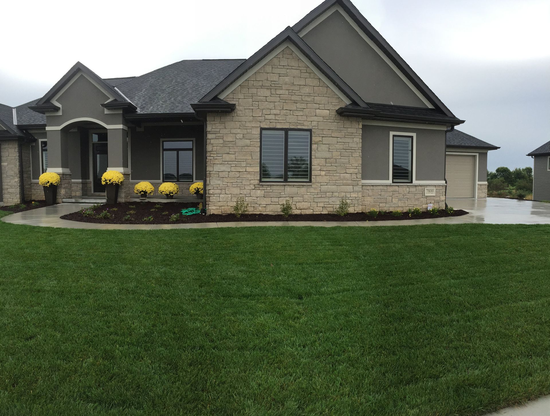 A large house with a lush green lawn in front of it.