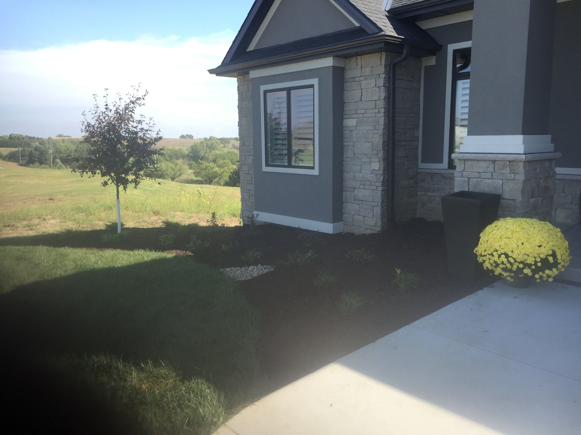 A house with a lot of windows and flowers in front of it