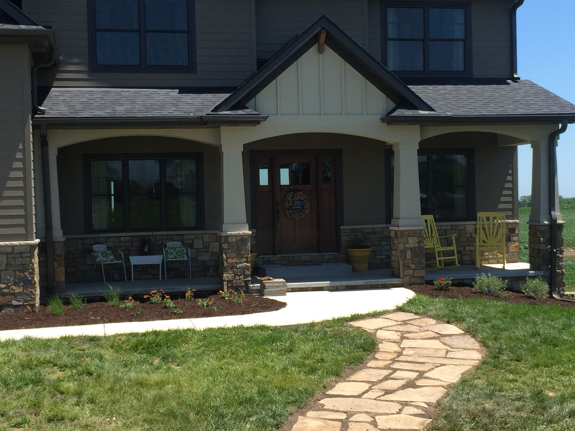 A house with a stone walkway leading to the front door