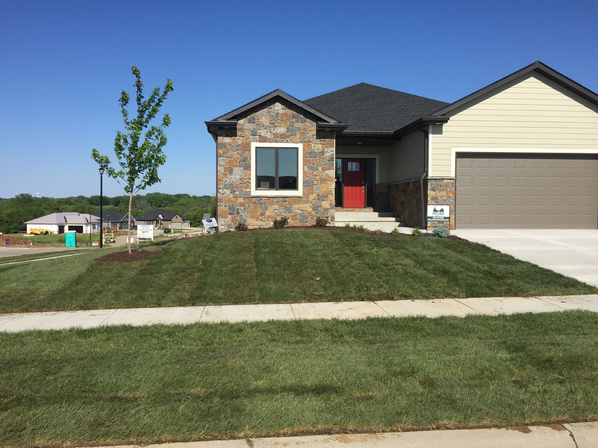 A house with a lush green lawn in front of it.