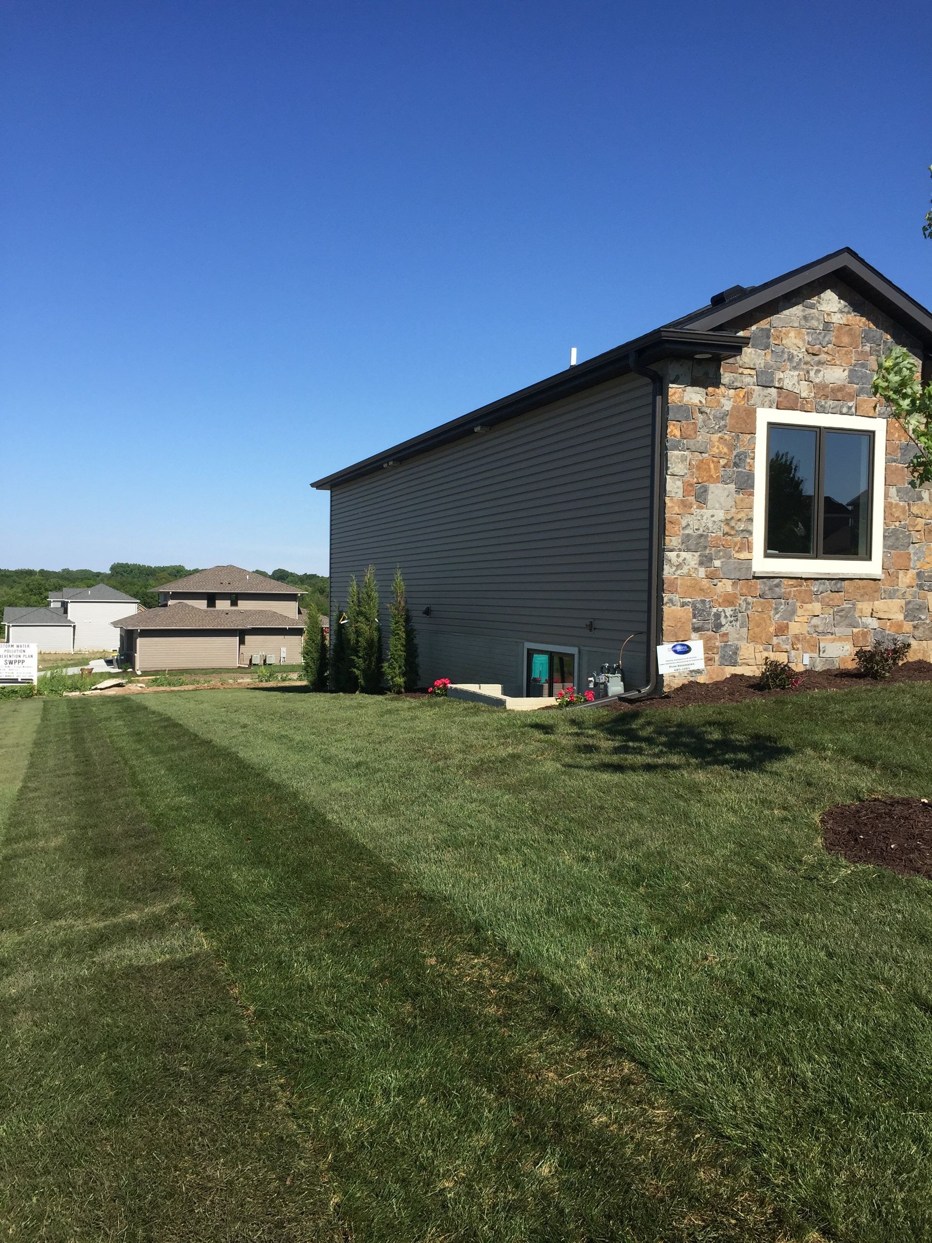 A house with a large lawn in front of it.