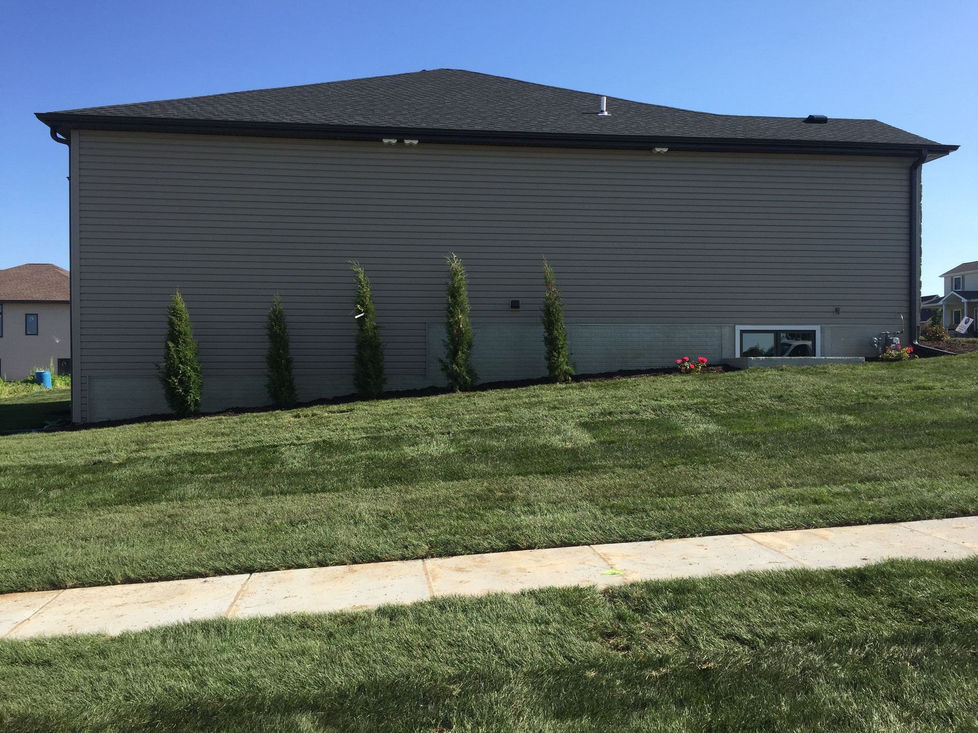 A large house with a lush green lawn in front of it.
