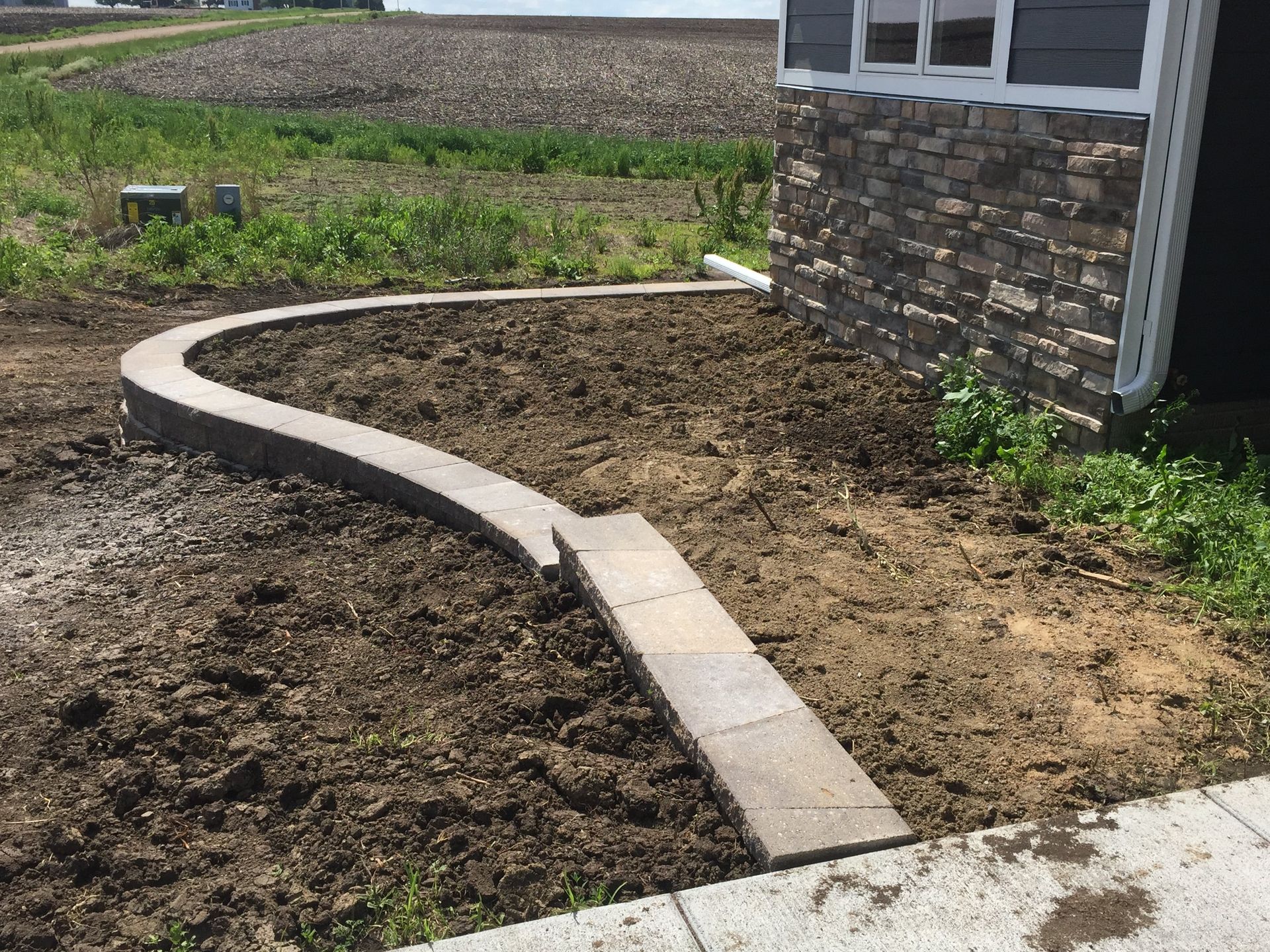 A sidewalk is being built in front of a house.