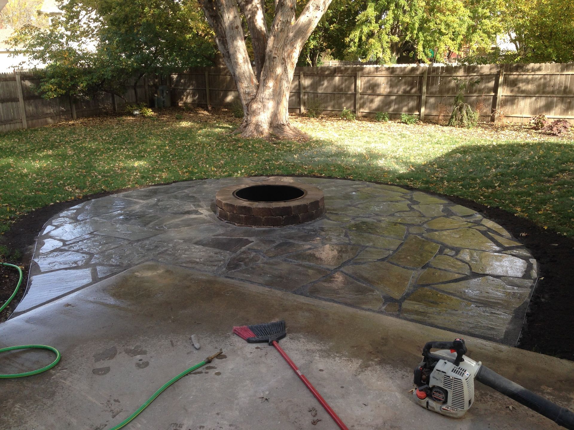 There is a fire pit in the middle of the patio.