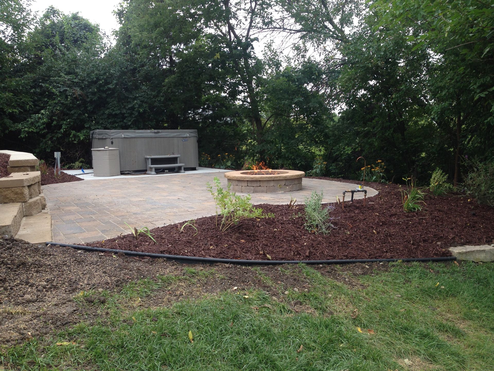 There is a fire pit in the middle of the backyard.