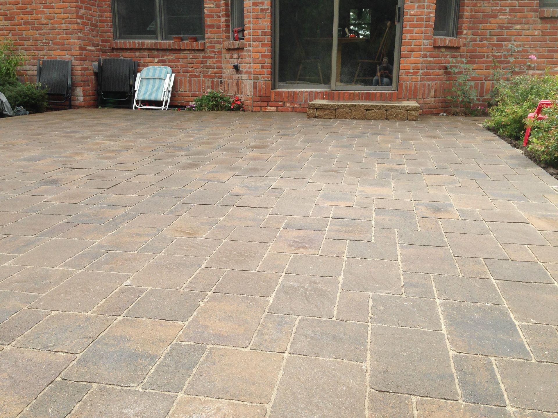 A brick house with a patio in front of it
