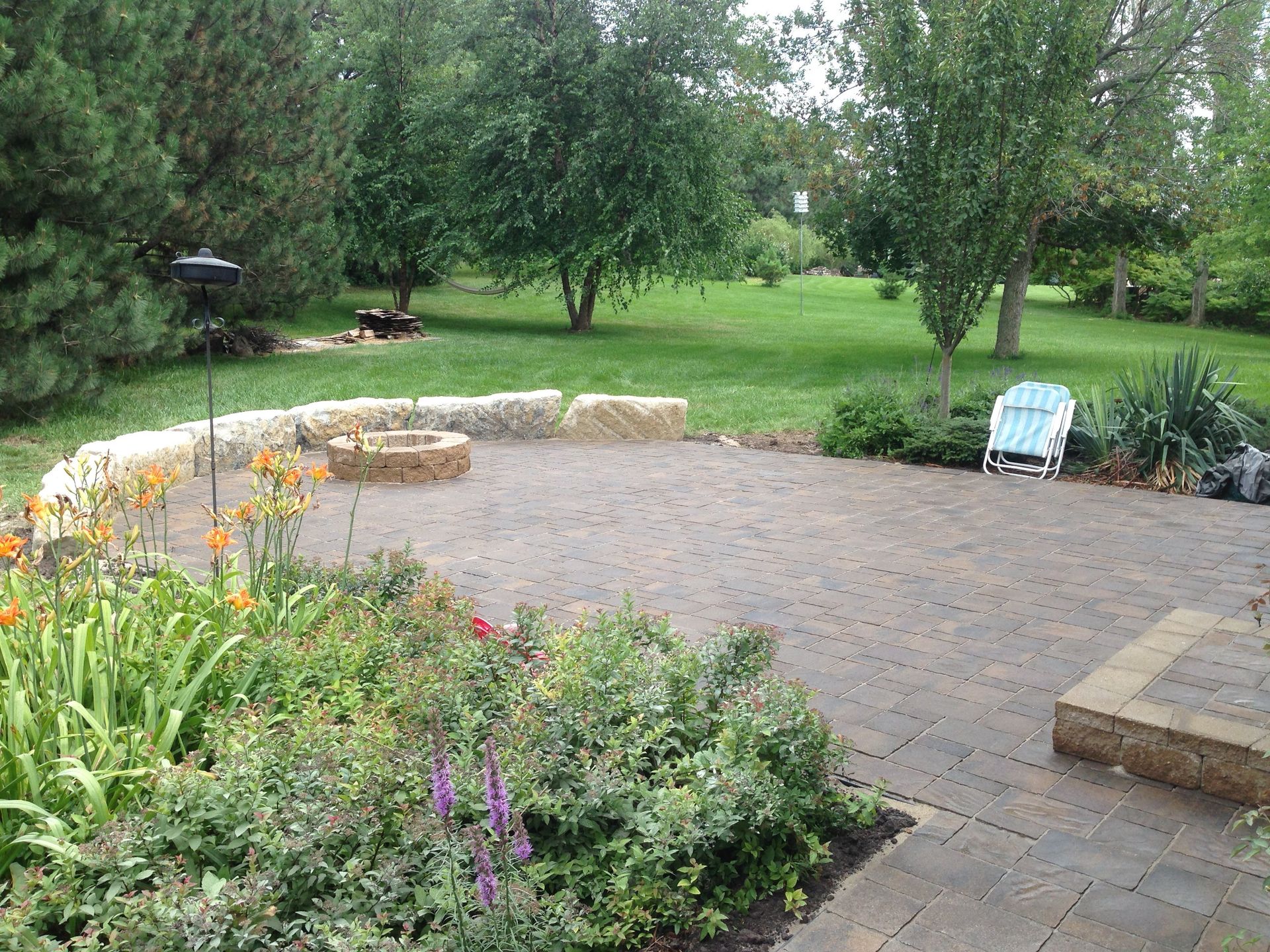 A patio with a fire pit in the middle of it
