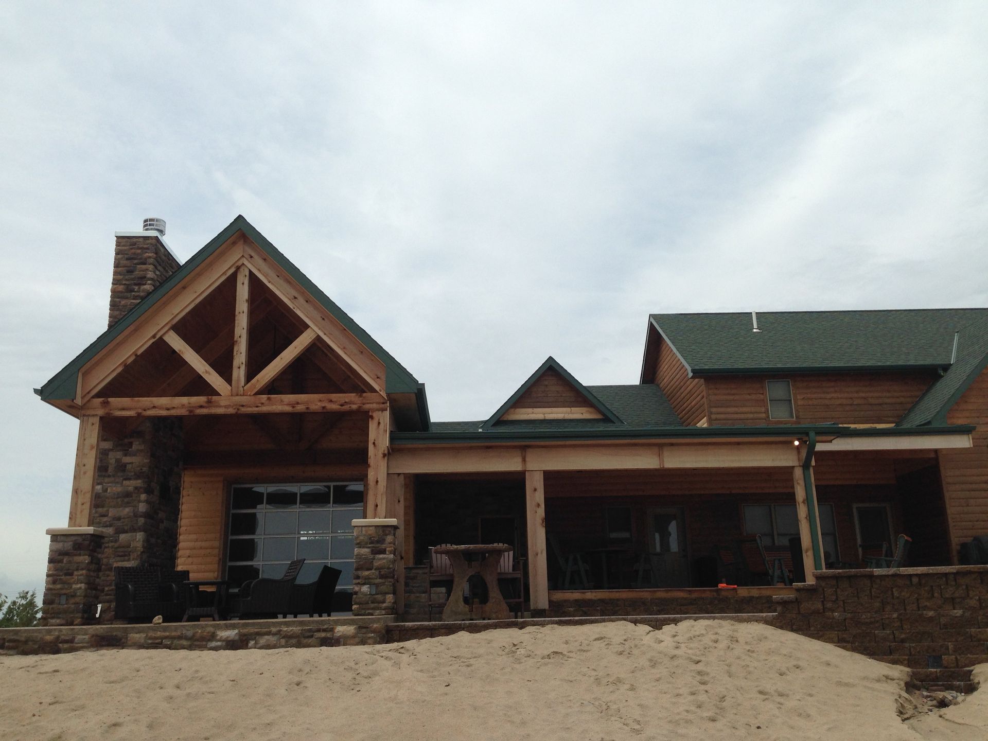 A large house with a green roof is under construction