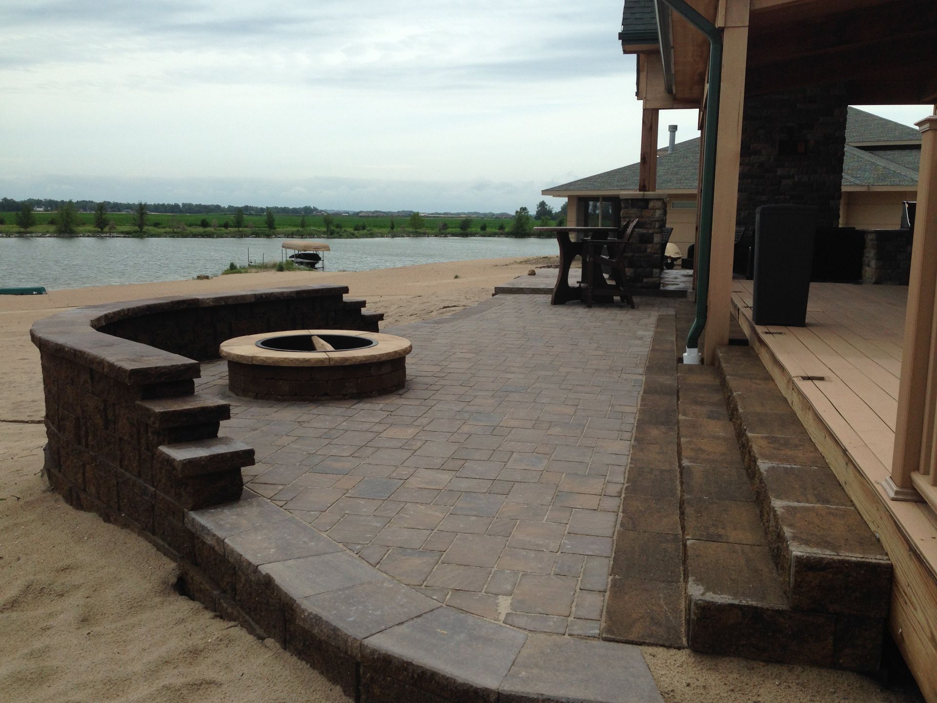 A patio with a fire pit in the middle of it