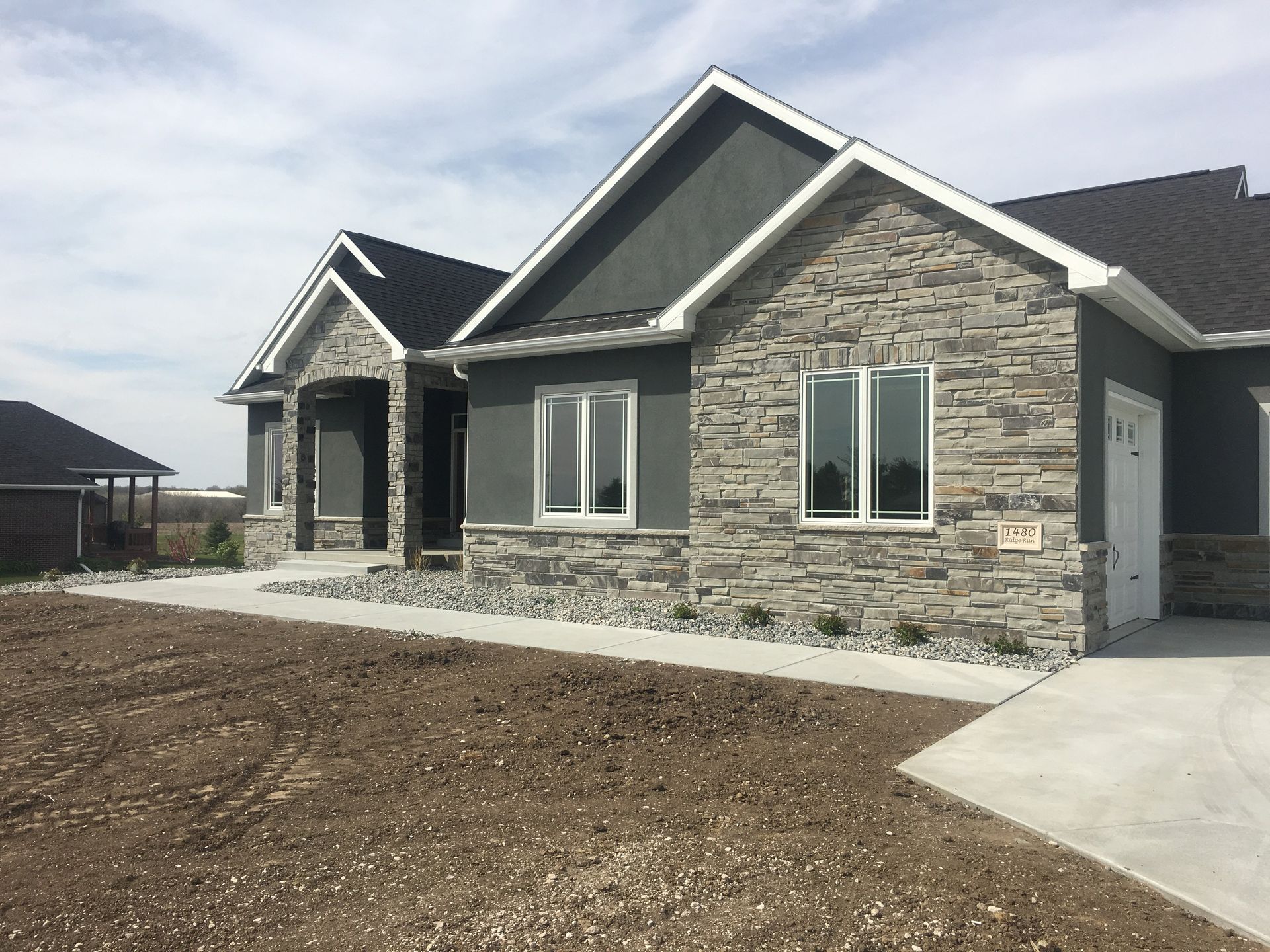 A house with a lot of windows and a stone facade