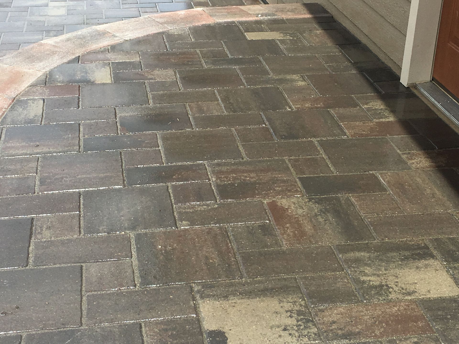 A brick walkway leading to a garage door