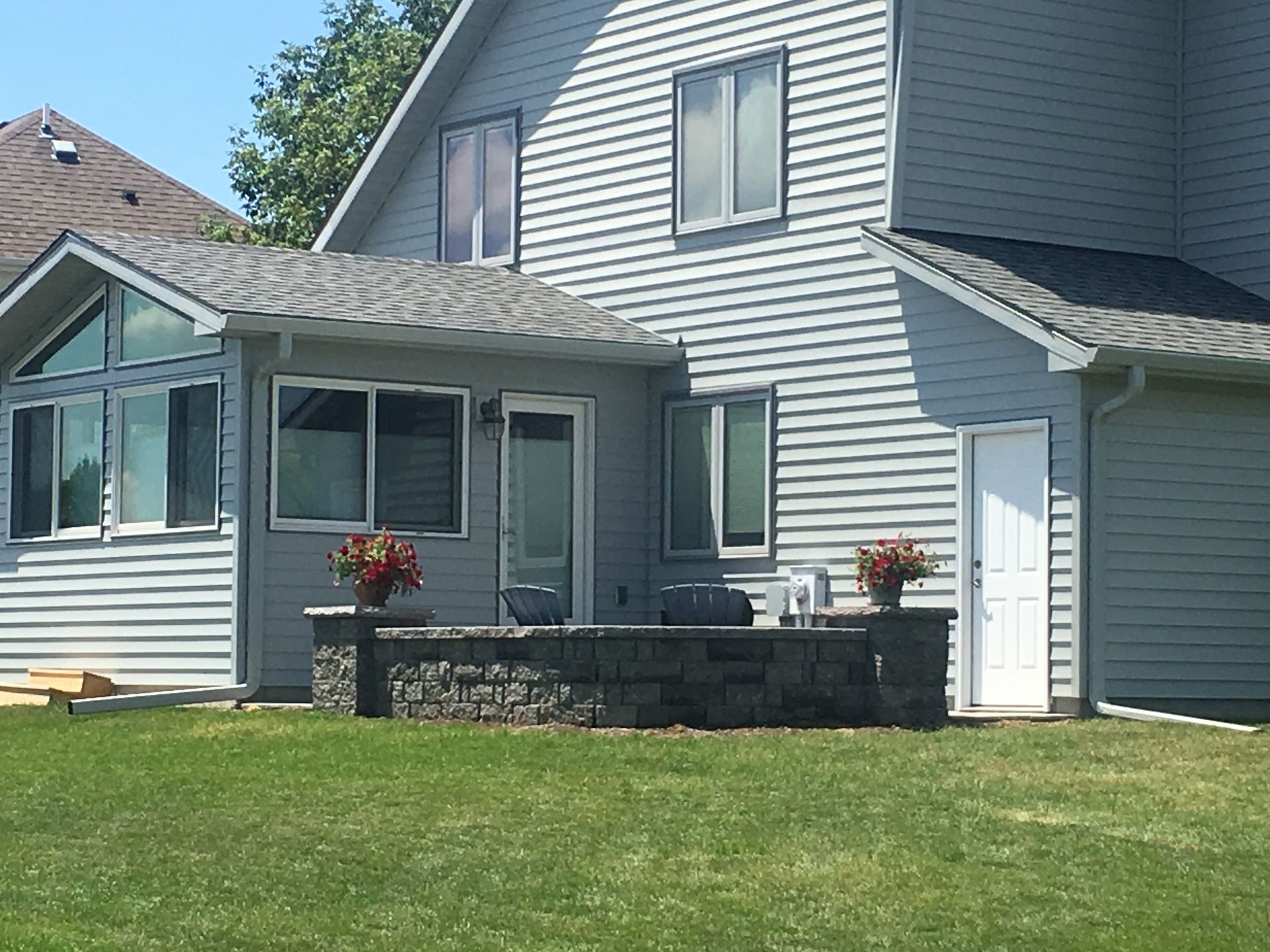 A house with a large lawn in front of it