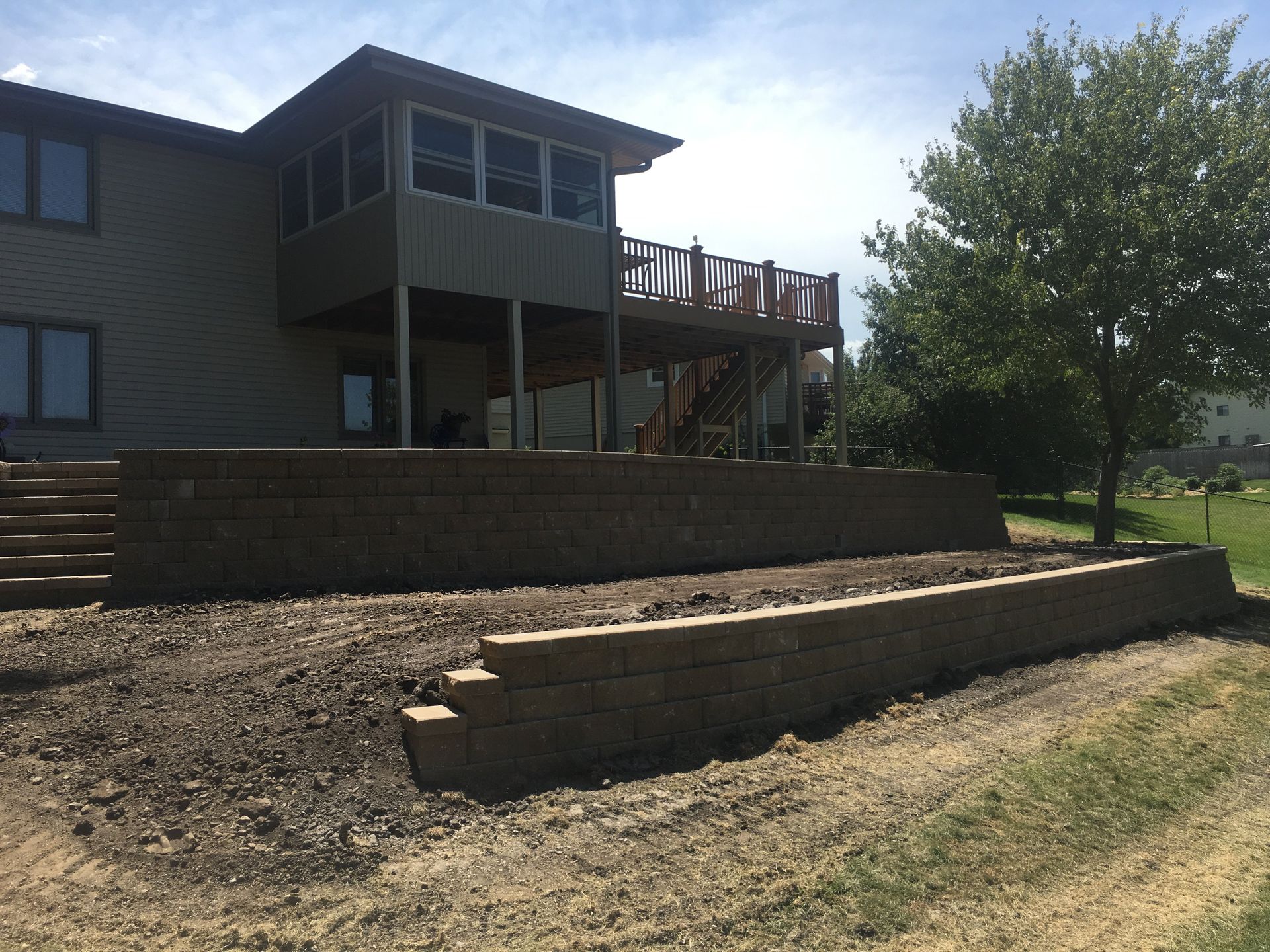 A large house with a large deck and stairs