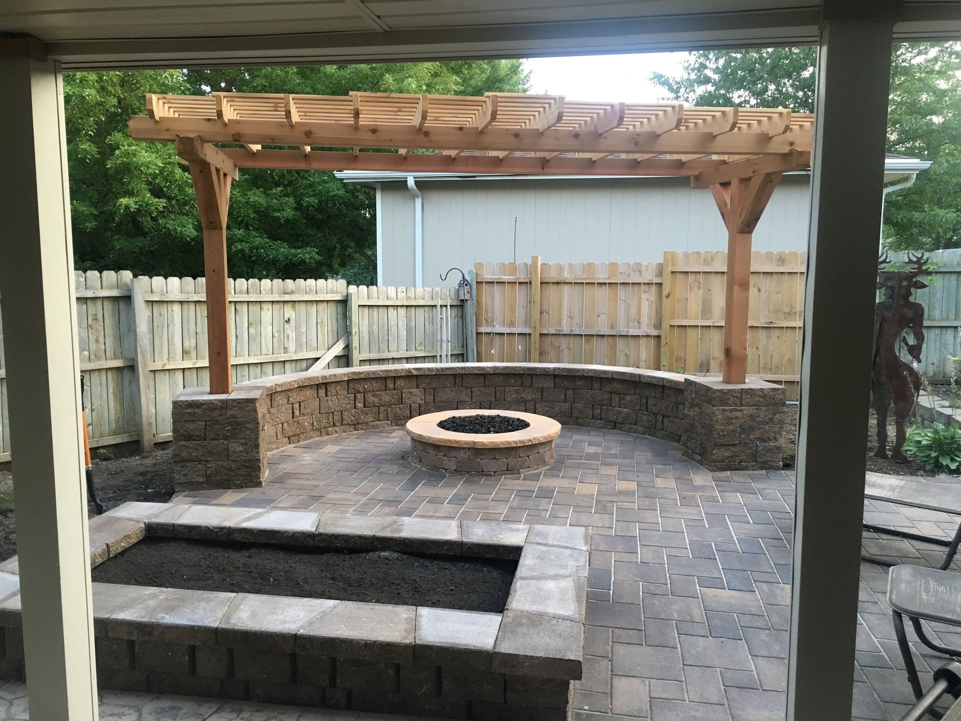 There is a fire pit in the middle of the patio.
