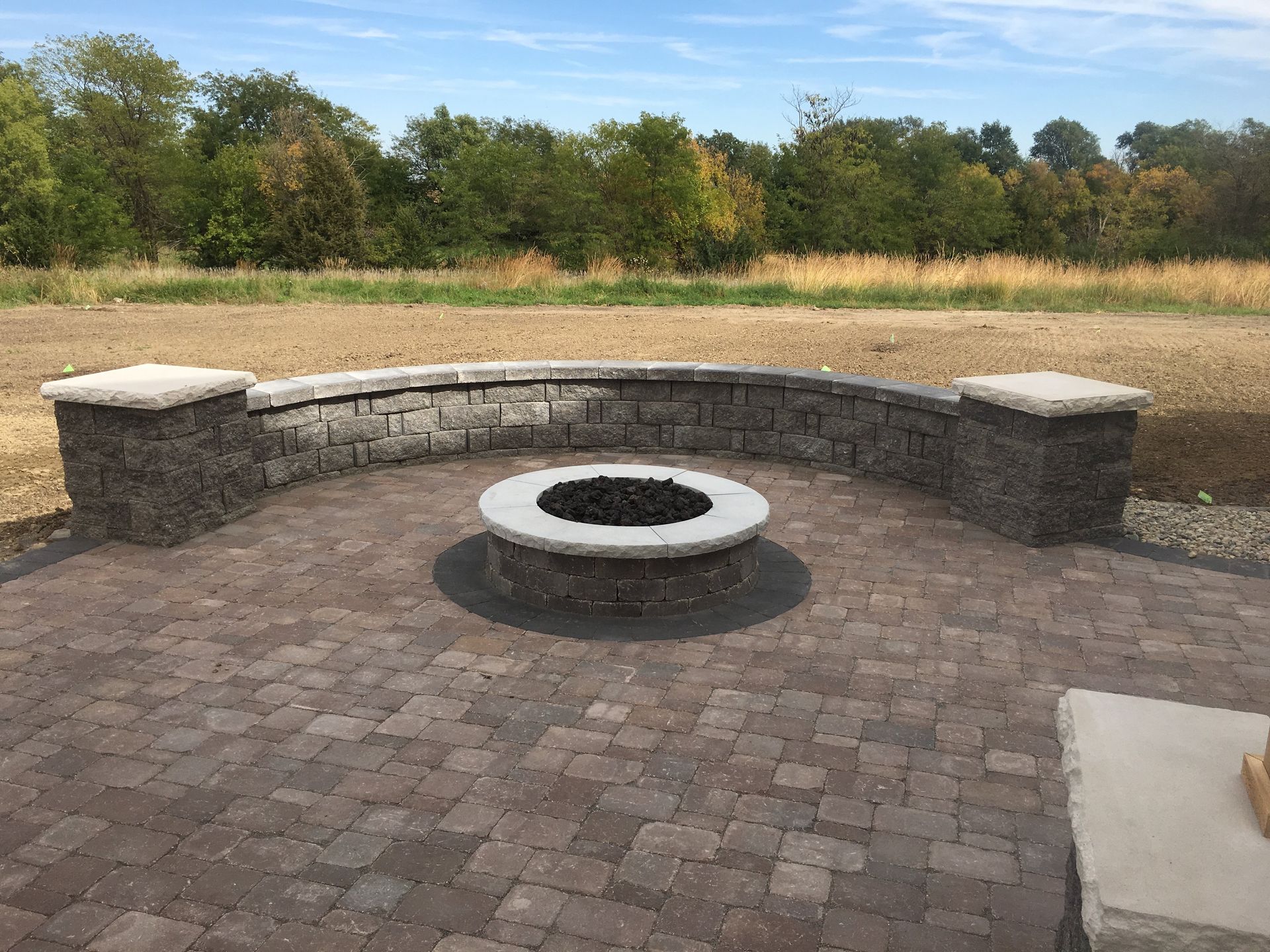 There is a fire pit in the middle of the patio.