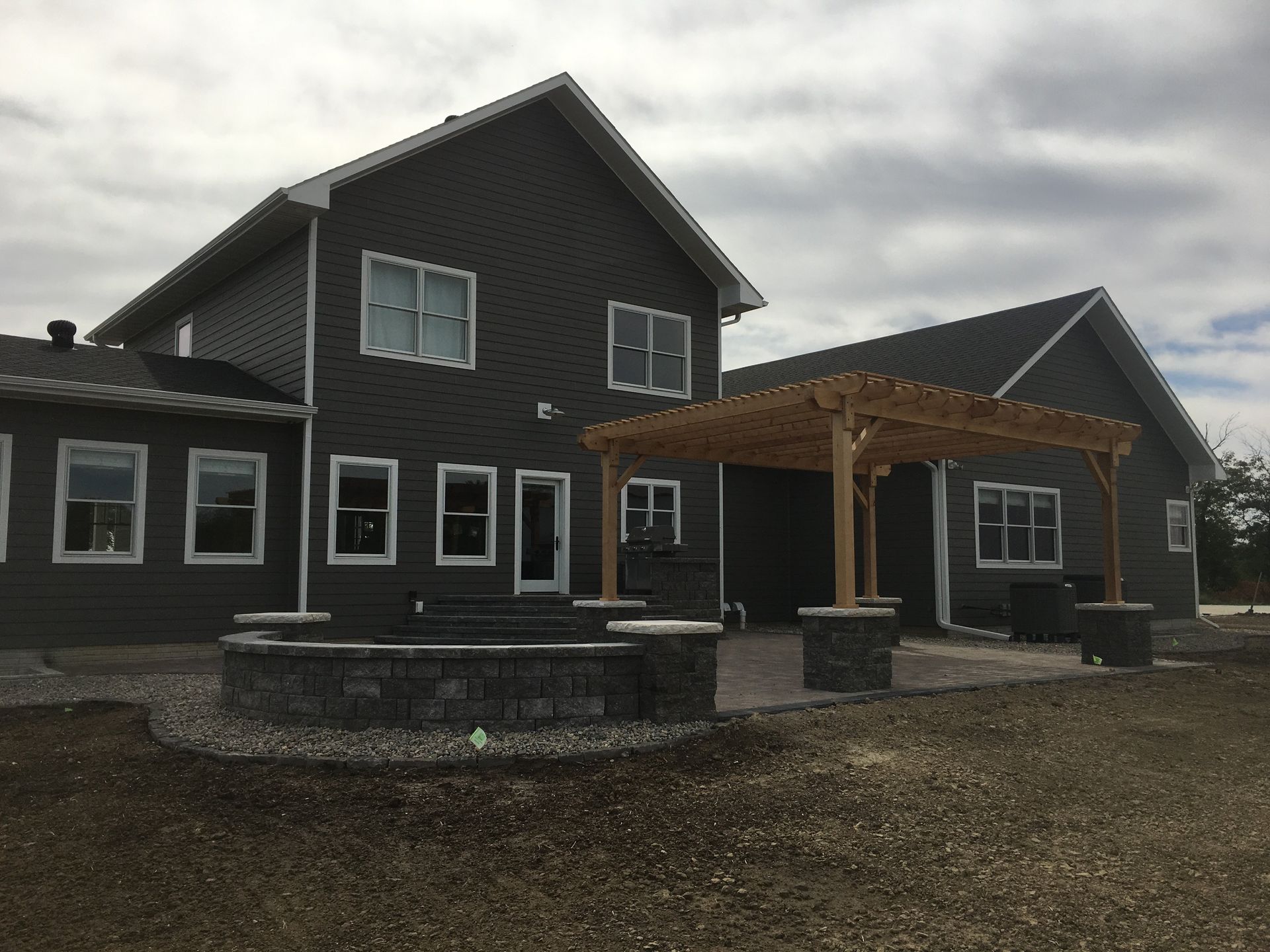 A large house with a pergola in front of it