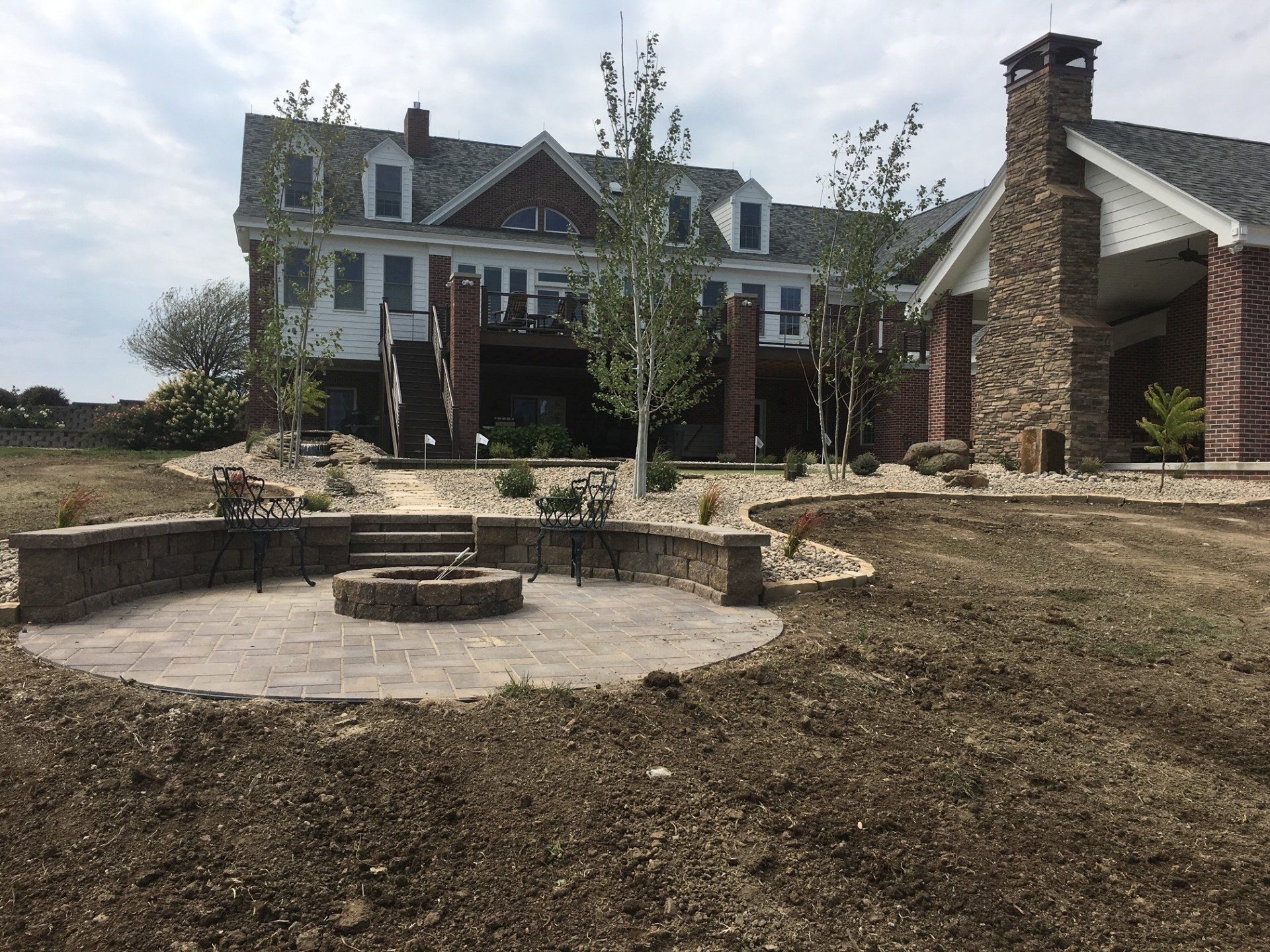 A large house with a fire pit in front of it
